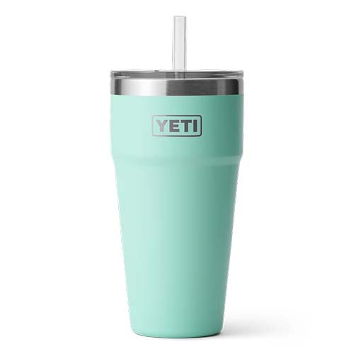 A Yeti travel mug with lid and straw.