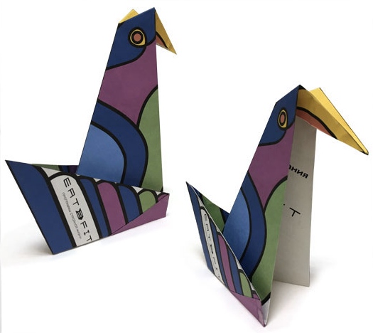 An origami brochure folded into a bird.