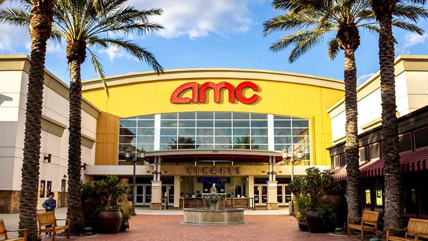 AMC theatre from the outside on a sunny day in a larger outdoor mall.