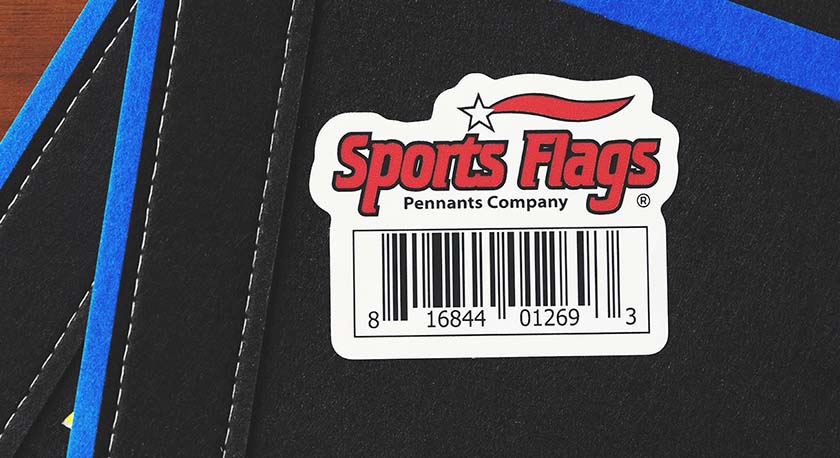 Close-up of a UPC sticker on a black and blue sports pennant.