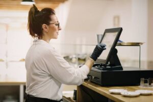 woman operating POS system