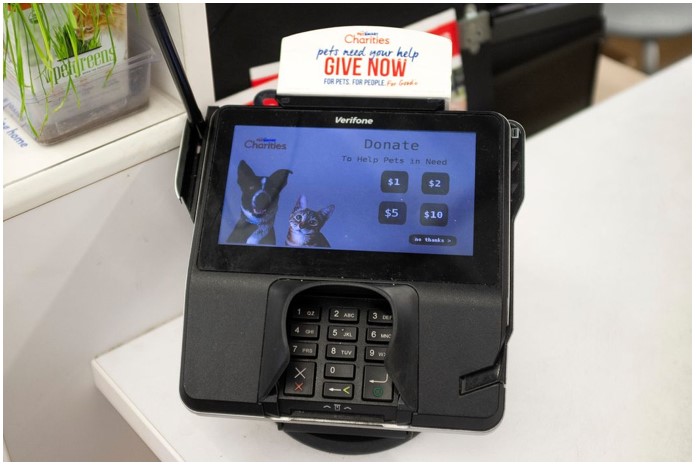 A point-of-sale terminal displaying the option to donate $1-$10 to help pets in need as a purchase is completed.