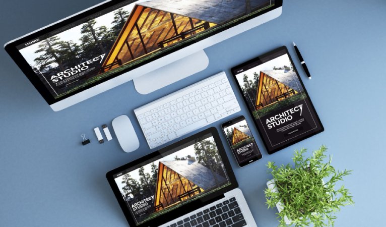 A colorful website with a house, shown on mobile, tablet, laptop, and desktop.