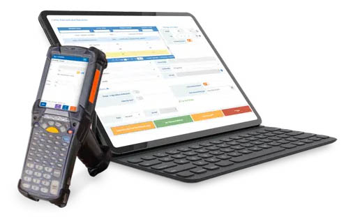 A mobile barcode scanner next to a tablet and keyboard with the Logiwa web app open on its screen.