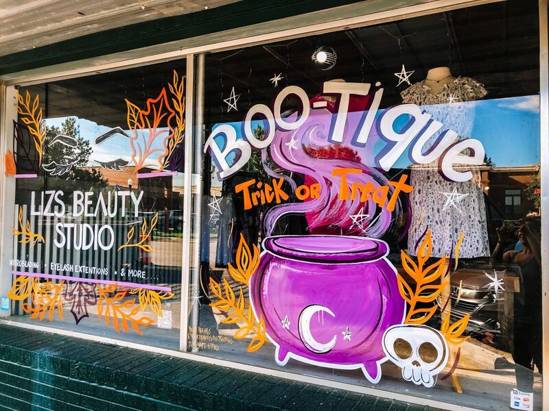 Halloween retail window display painted purple cauldron trick or treat