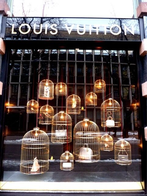 Louis Vuitton halloween window retail display candles bags and gold bird cages