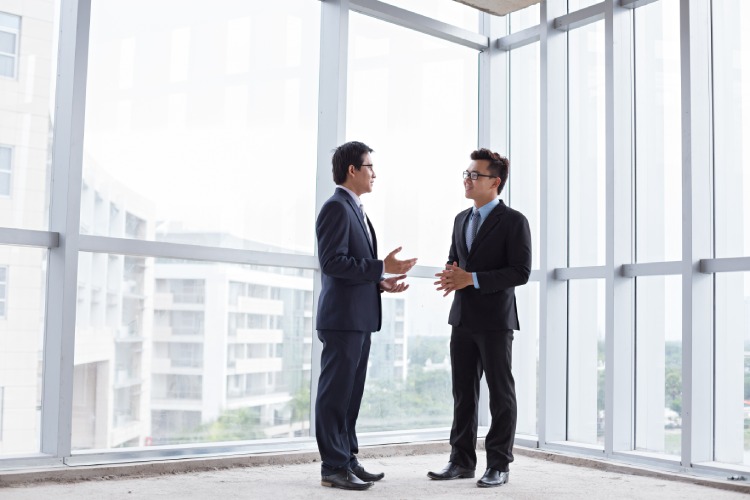 Two real estate agents negotiating for their clients. 