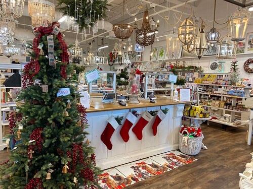 Lighting store with checkout counter decorated with stockings and a Christmas tree. 