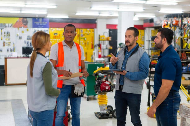 Hardware store with 4-person staff standing in a circle receiving instructions. 