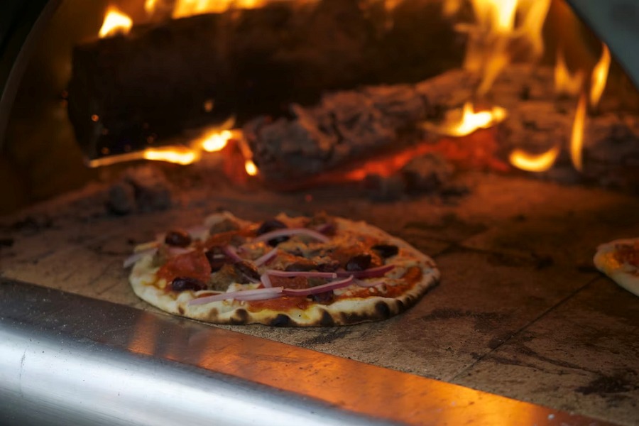 Pizza cooking in a wood fired oven