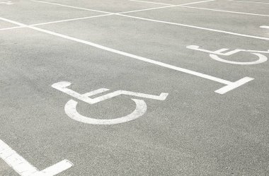 Parking spaces marked with handicapped symbol.