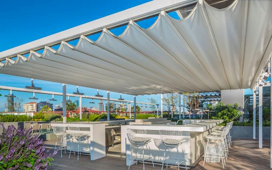 A wide retractable awning covering the bar at a restaurant deck.