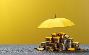An umbrella and coins symbolize insurance.
