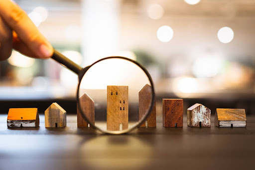 An image of small houses with a magnifying glass