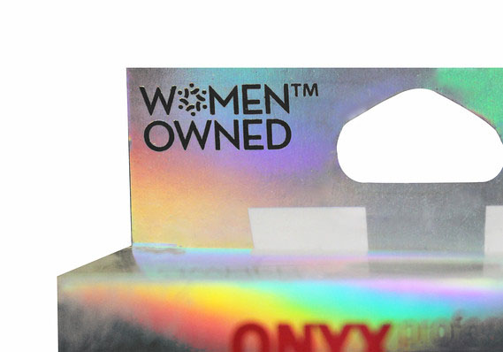 A section of a rainbow-colored product package featuring a 'Women Owned' stamp.