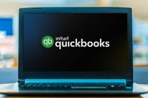 Laptop computer displaying logo of QuickBooks.