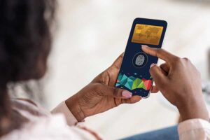 Black lady paying online using biometrics.