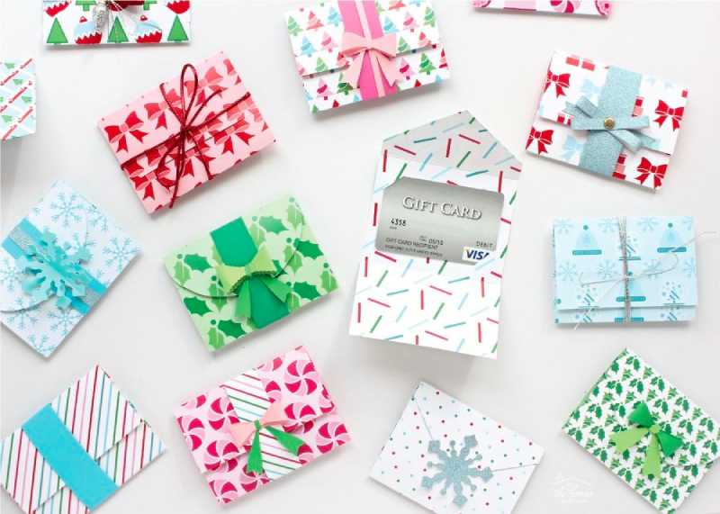  grey background with a bunch of holiday-wrapped gift cards.