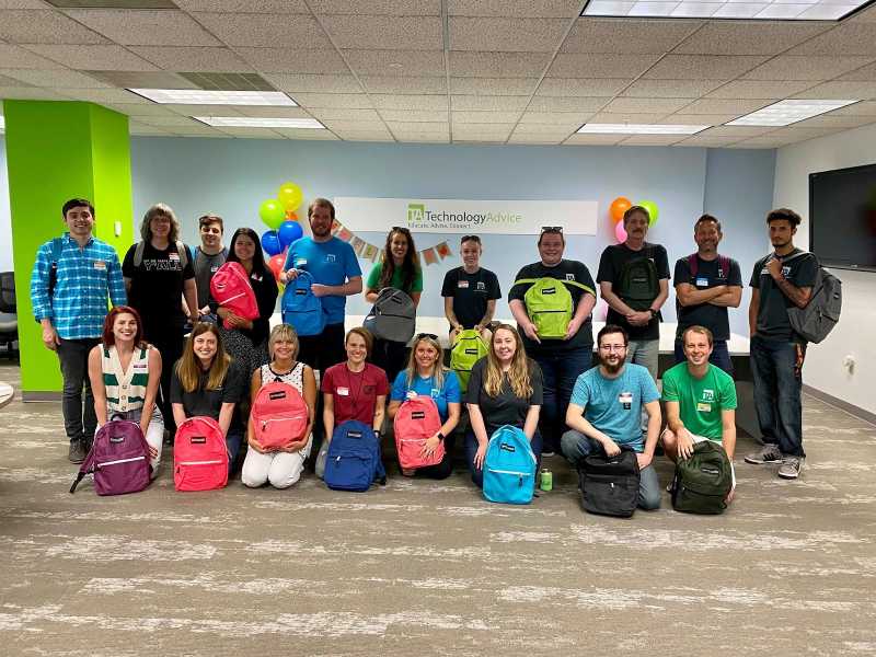TechnologyAdvice volunteers to pack backpacks for a local charity.