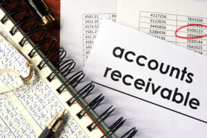 Open book with figures and paper with words accounts receivable.