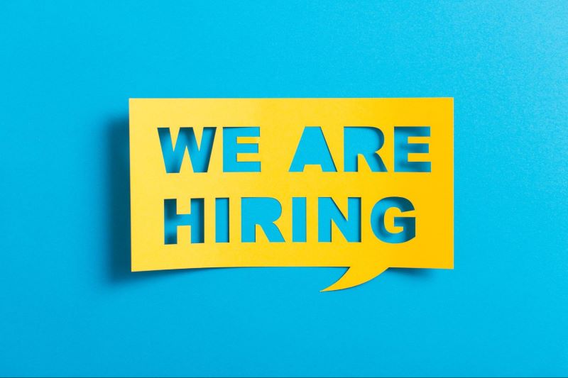 We are Hiring cutout on yellow paper