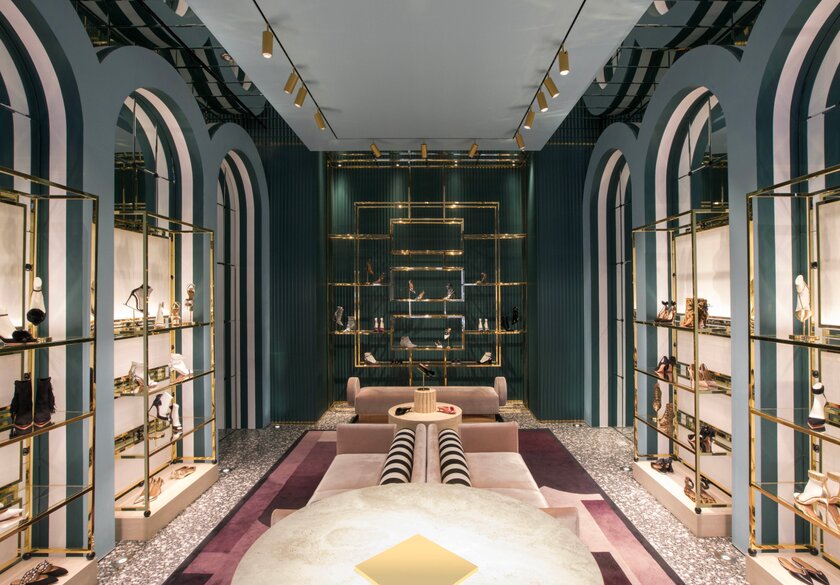 Shoe boutique with green walls and golden shelves