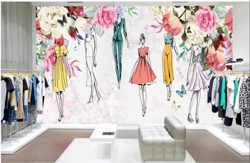 Store with a large mural of fashion sketches on back wall and racks on side walls