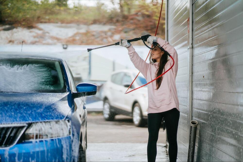Woman washing a car