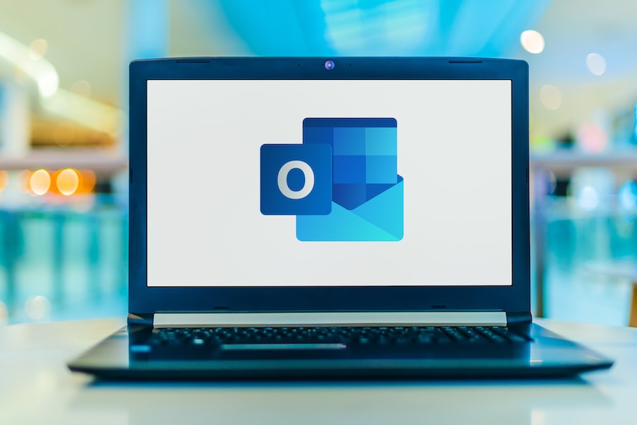 Laptop computer displaying logo of Microsoft Outlook.