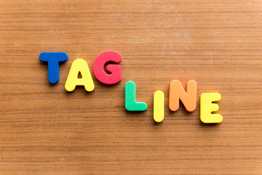 Vibrantly colored letter blocks arranged to spell out the word 'TAGLINE', standing out with playful hues and dynamic arrangement.