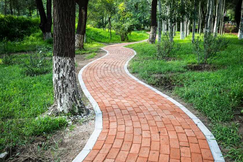 A brick path in a park.