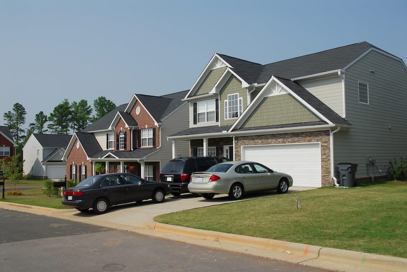 Cars parked in a residential house driveway.