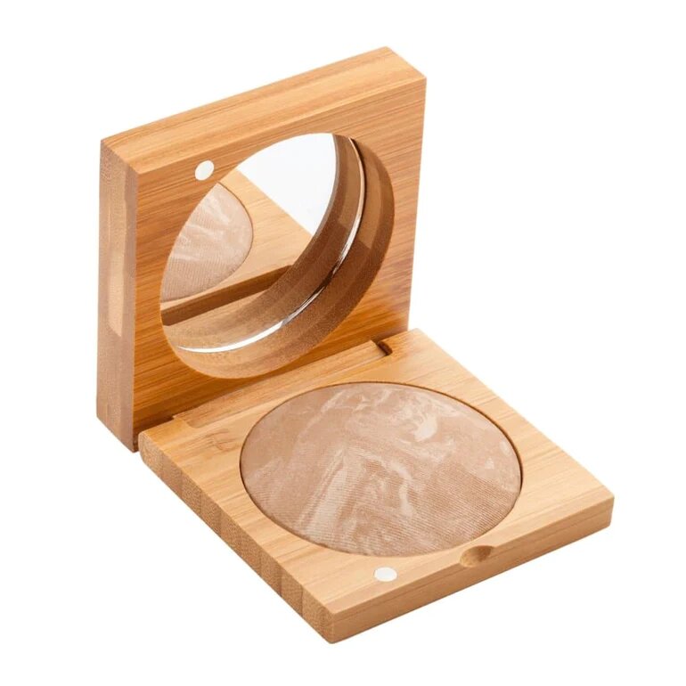 A cosmetic compact made of bamboo with a mirror and brown powder makeup.