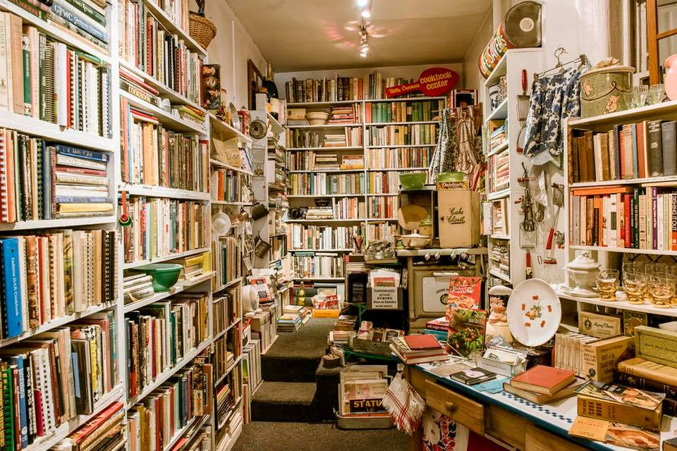 Interior of Bonnie Slotnick Cookbooks with bookshelves and antique trinkets