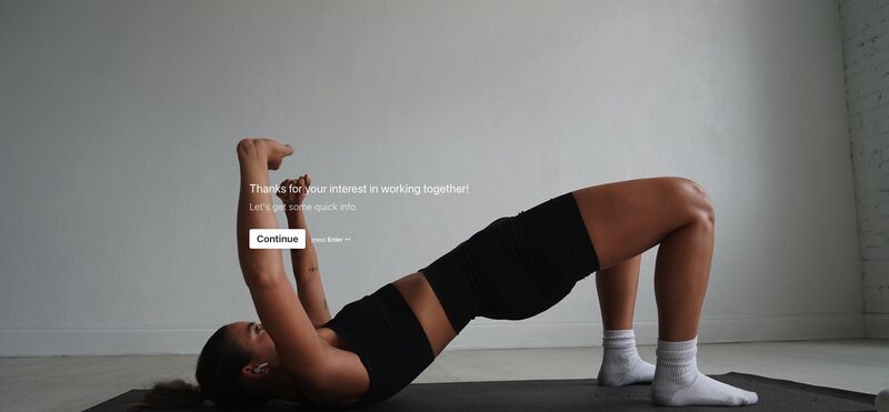 Kortni King personal training sign-up page with back ground image of her doing a hip thrust. 