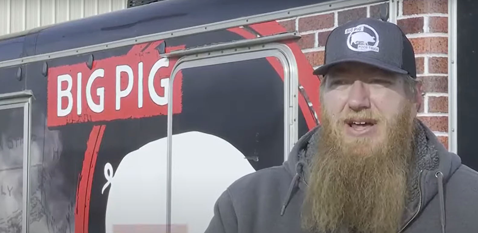 Matt Sneezy in front of his Big Pig food truck.