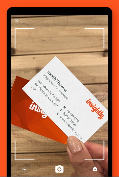 Insightly CRM's business card scanner using the mobile app's camera to capture contact details on the card.