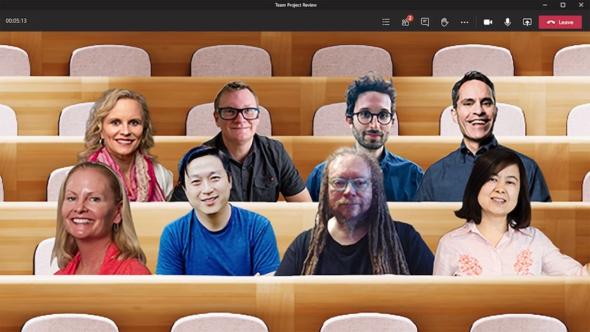 Microsoft Teams interface showing eight participants sitting in a digitally simulated auditorium.