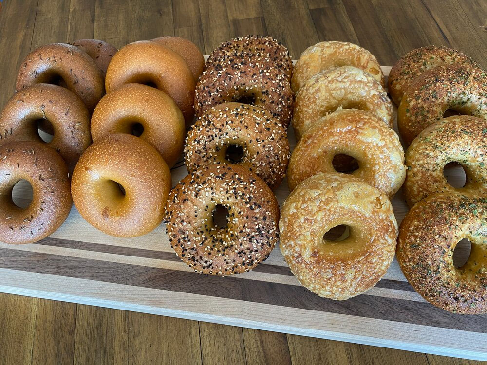 A variety of Salt Spoon bagels on a cutting board.