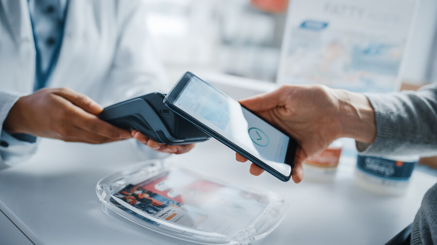 Seller and a Customer Using NFC Smartphone with Contactless Payment. Digital payment concept.
