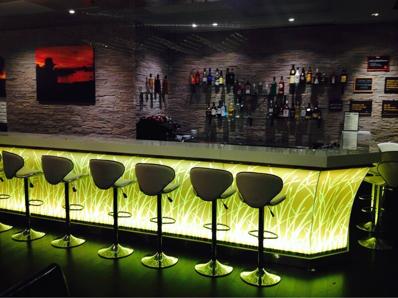 picture of a stocked bar with moody lighting