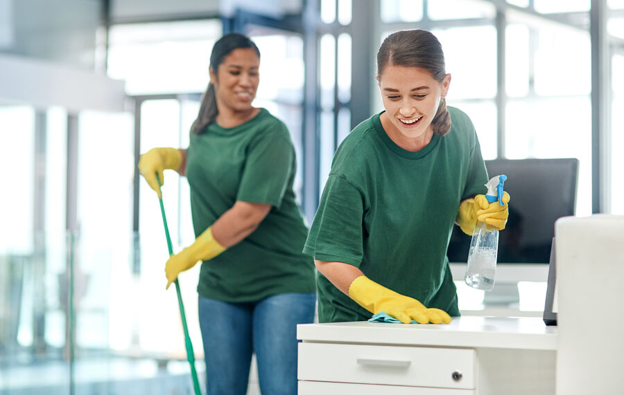 The deepest clean for complete peace of mind. Shot of two young woman cleaning a modern office.