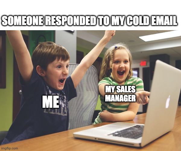 Two happy children looking into a laptop screen depicting a sales rep and a sales manager when a cold email gets an answer.