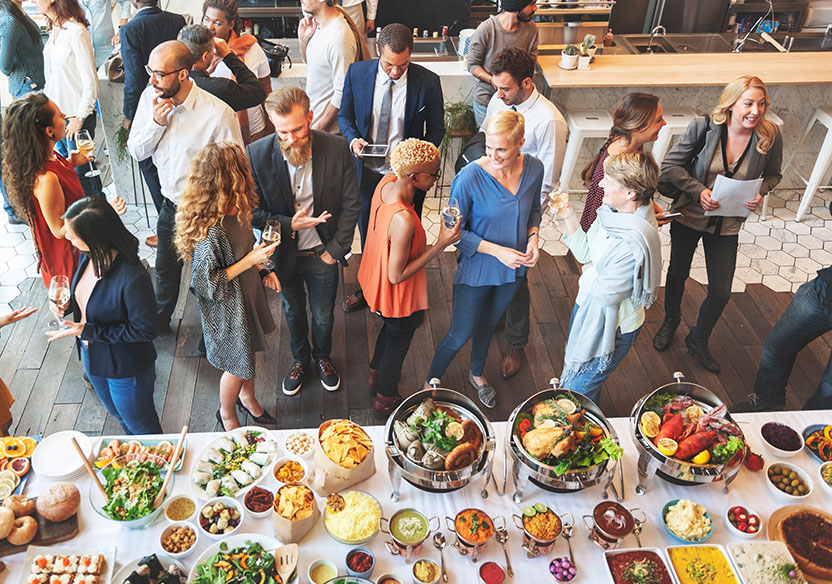 Photo of people gathering around food.