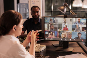 Office manager talking with employees on videocall meeting.