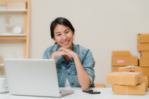 Woman smiling infront of laptop