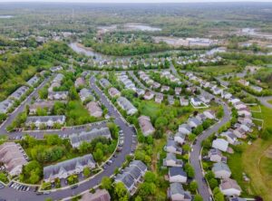 A small town from a height suburban neighborhood with roofs of houses urban landscape.