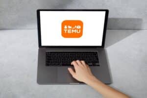 The Temu logo shown on a laptop screen.