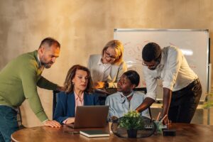 businesspeople with laptop collaborating on project at office