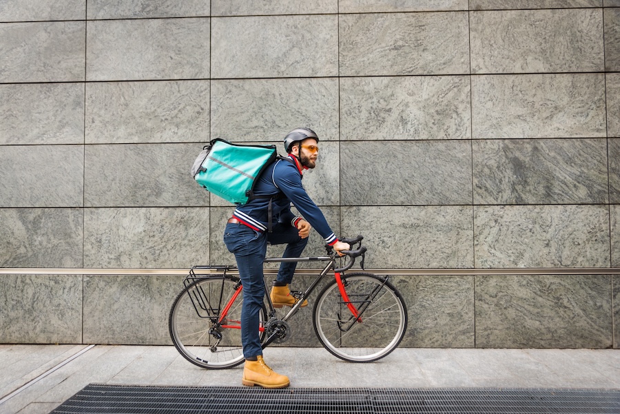 Food delivery, rider with bicycle delivering food as gig.